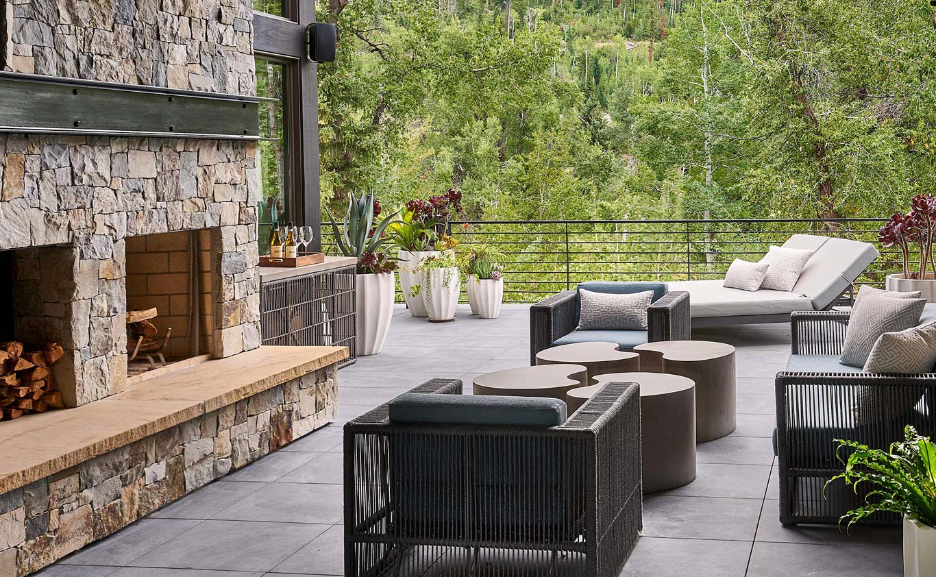 Outdoor lounge area with fireplace and seating